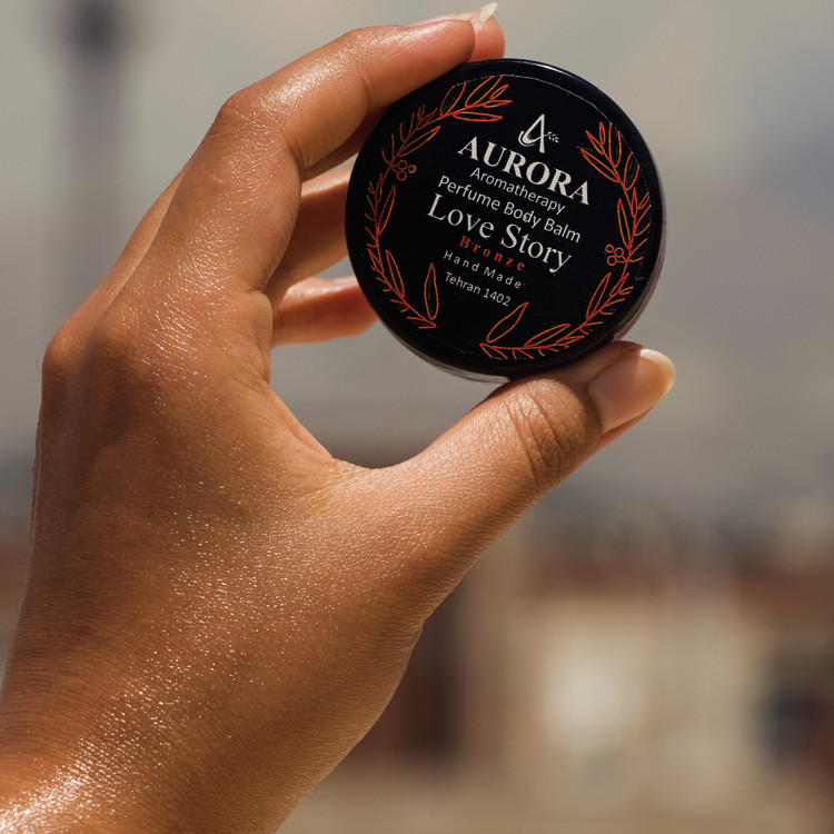 عطر جامد (بالم عطری) آرورا با رایحه لاو استوری برنز